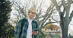 Walking, student and man with smartphone, nature and communication on social media, texting and app. Typing, message and travel to university with mobile, outdoor and chat with contact on website