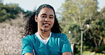 Happy woman, face and nurse with confidence in nature for medical or community health service. Portrait, female person or nursing volunteer with smile or arms crossed in park for healthcare residency