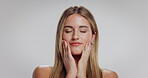 Face, feeling and skincare with happy woman in studio for cosmetics or dermatology results. Aesthetic, beauty and satisfaction with model touching skin on white background for cosmetology benefits