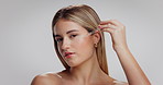 Face, serum and woman in studio, cosmetics and skincare oil routine on white background. Space, dropper and person with wellness, shine and glow with hydration, retinol dermatology or hyaluronic acid