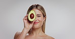 Beauty, avocado and face of woman in studio with skincare, natural and moisturizing benefits for health. Mockup space, portrait and person with fruit for glow with dermatology by white background.