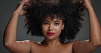 Haircare, happy and woman with makeup in studio, luxury conditioner or hydrate for healthy coil texture. Smile, portrait and African lady with afro, space and keratin treatment on gray background