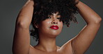 Face, woman and beauty for hair care in studio for detangling, natural growth and afro volume. Portrait, African female person and proud of texture, maintenance and scalp treatment on gray background