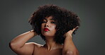 Face, woman and touch for hair care in studio of beauty, natural growth and afro volume. Portrait, African female person and textures for hairstyle, maintenance and scalp treatment on gray background