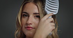 Woman, face and hairbrush in studio with grooming routine, beauty and confidence on background. Girl, person and hairstyle with self care, tools or text with hygiene, cosmetics and pride in Italy