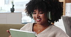 Happy, tablet and black woman on sofa with headphones for watching movies, online videos and laughing. Home, living room and person on digital tech relax for entertainment, funny film and streaming