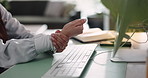 Person, hands and computer with wrist pain for injury or overworked muscle tension in home office. Closeup, freelancer or remote work typing with sore arm for carpal tunnel syndrome or arthritis