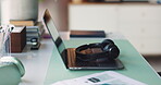 Break, headphones and laptop on desk in home office for planning, remote work or research. Computer, creative workstation and documents in empty apartment for freelance or small business startup