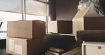 Boxes, moving in or relocation with empty room in new home for property investment and unpacking. Real estate, rent or house mortgage with cardboard package for apartment, housing or accommodation