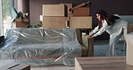 Woman, sofa and moving in new home with furniture to relax for rest, break or comfort in apartment. Female person, homeowner or relocation with boxes or interior for fresh start or property in house