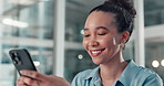 Woman, phone and texting at startup with contact, laugh or funny meme in office at media company. Person, smartphone and break with app, notification and happy with social network at creative agency