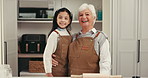 Happy, baking and face of child with grandmother in kitchen for pride, bonding or connection. Smile, learning and portrait of girl kid with senior woman in retirement with pride for dessert in home