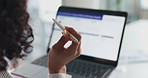 Woman, hands and thinking with pen on laptop for financial investment or accouunting in office. Female person, back and contemplating with computer or app for online research, finance or information