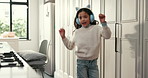 Kid, dancing and girl in kitchen, headphones and energy with happiness, sound and radio. Home, dancer or child development with headset, movement or album playlist with subscription for song or audio