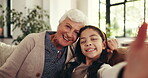 Love, grandma and selfie with child, home or bonding on visit in lounge, happy or affection for girl. Laughing, old woman and memory with kid in living room, profile picture and photography in house