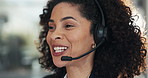 Woman, headset and happy at call center for legal aid, consulting and advisory services at office. Person, agent and discussion with voip mic, solution and problem solving with contact at law firm