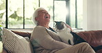 Senior woman, cat and happy on sofa, play and laugh for cuddle, stroke and love with bonding in home. Elderly person, feline animal and smile with pet, connection or relax on couch in retirement