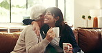 House, hug and mother with adult daughter, smile and bonding together in living room. Apartment, family and parent on couch, support and embrace with happiness, love and trust with coffee and reunion