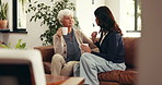 Coffee, conversation and woman with senior mom on sofa in home for advice, bonding or connection. Happy, tea and female person with elderly mother for talking, catch up or discussion in living room.