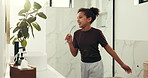 Happy, dance and child with brush in bathroom for hygiene, grooming and wellness for morning routine. Beauty, house and girl with energy for singing, movement and karaoke in home for childhood