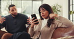 Couple, ignore and conflict with phone on sofa in home for argument, disagreement or fight. Frustrated man, talking and woman with mobile smartphone for separation, isolation or poor communication