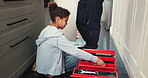 Repair, kitchen and girl with box of tools for home construction, fixing and plumbing maintenance. Manual labor, DIY father and daughter pack equipment after working on sewer pipe, sink and plumbing