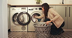 Woman, washing machine and housekeeping in home with clothes for cleaning, laundry or chores. Female person, fabric hygiene and appliance with routine in house with basket, fresh linen and loading