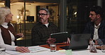 Business people, night and meeting with tablet for project discussion or performance review. Group, employees or analyst working late with technology, documents or laptop for analytics or statistics