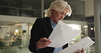 Thinking, paperwork and businesswoman in office at night with finance report for company budget plan. Writing, ideas and mature female financial manager with investment proposal with deadline.
