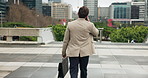 Phone call, walking and back of businessman in city with finance negotiation, contact or networking. Briefcase, cellphone and male financial manager on mobile discussion for investment deal in town.