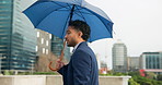 City, walking and businessman stress with umbrella for travel, morning commute and journey to work. Lawyer, attorney and person with weather anxiety in urban town for trip with metro and opportunity
