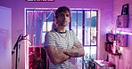 Arms crossed, face and neon with man in tattoo parlor as owner of small business or startup. Creative, ink and store with confident artist in studio shop for body art, culture or professionalism