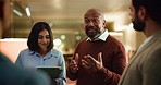 Night, discussion and team of business people in office on tablet for feedback, article ideas and meeting. Creative, media agency and men with women brainstorming for news story, planning and report