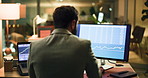 Businessman, night or trading with screen for stock market research, data or statistics in office. Back, broker or investor working late with technology display or app for cryptocurrency in workplace