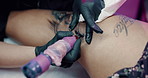 Hands, gloves and tattoo machine with artist in studio for leg art, unique design and linework. Small business, client and permanent body ink in parlor for aesthetic, creative process and decoration