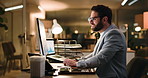 Man, typing and computer at office, night or review for stock market, research and trading at company. Person, investor and perspective with smile for revenue stats, feedback and insight at agency