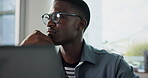 Thinking, programmer and black man with laptop in office, planning or idea for software development. Programming, IT specialist and person with eyewear, reflection or problem solving with code on web