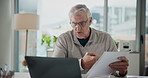 Mature, businessman and video call with documents on laptop for business proposal in office. Man, employee or discussion with computer or app for online meeting, webinar or conversation in workplace