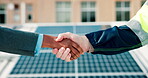 Handshake, people and solar panels with partner for engineering, installation and renewable energy source. Engineer, photovoltaic grid and team shaking hands for sustainability and alternative power