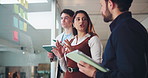 Business people, brainstorming or planning with sticky note for schedule or team strategy in office. Group, employees or colleagues with tablet for tasks, agenda or project ideas on glass board