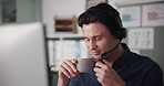 Headset, coffee and call center consultant in office with communication, crm or contact us. Professional, mic and male technical support agent with consultation for customer service in workplace.
