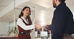 Talking, woman and man in office, handshake and planning for deal, public relations or working late. Night, publicist and shaking hands with client for agreement, smile and collaboration in business