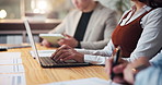 Hands, laptop and typing with business people in boardroom for meeting or upskill workshop. Computer, notes and seminar with employee team at table in office together for development or training