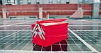 Toolbox, solar panel and sustainability outdoor on rooftop with electrician equipment for environment. Urban development, innovation and clean energy for grid, engineering or photovoltaic maintenance