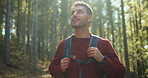 Happy man, outdoor or hiking with bag in forest for natural sightseeing, journey or adventure. Male person, hiker or smile with backpack, trees or wilderness for trekking or exploration in nature