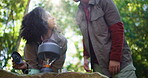Camping, water and kettle with couple in nature for brewing coffee, trekking rest stop and help. Adventure holiday, gas canister and tea pot with low angle of people in forest for travel and smile