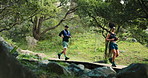 Fitness, couple and running exercise in woods together for outdoor workout, challenge and cardio. Runner, man and woman on forest bridge for health, wellness and marathon training with nature.