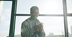 Phone, window and business black man in office on break for networking, check emails and internet. Creative agency, happy and person on smartphone for online message, contact and research on website