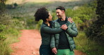 Couple, hike and fitness in forest with hugging, laughing and smiling for relationship goals. Happy, people and sports in nature with in love eye contact, health and walking for active wellness.