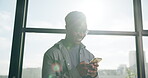 Below, creative and black man with phone in office for research, contact source or confirm schedule. Journalist, lens flare and mobile for editor feedback, fact check and online draft for publication